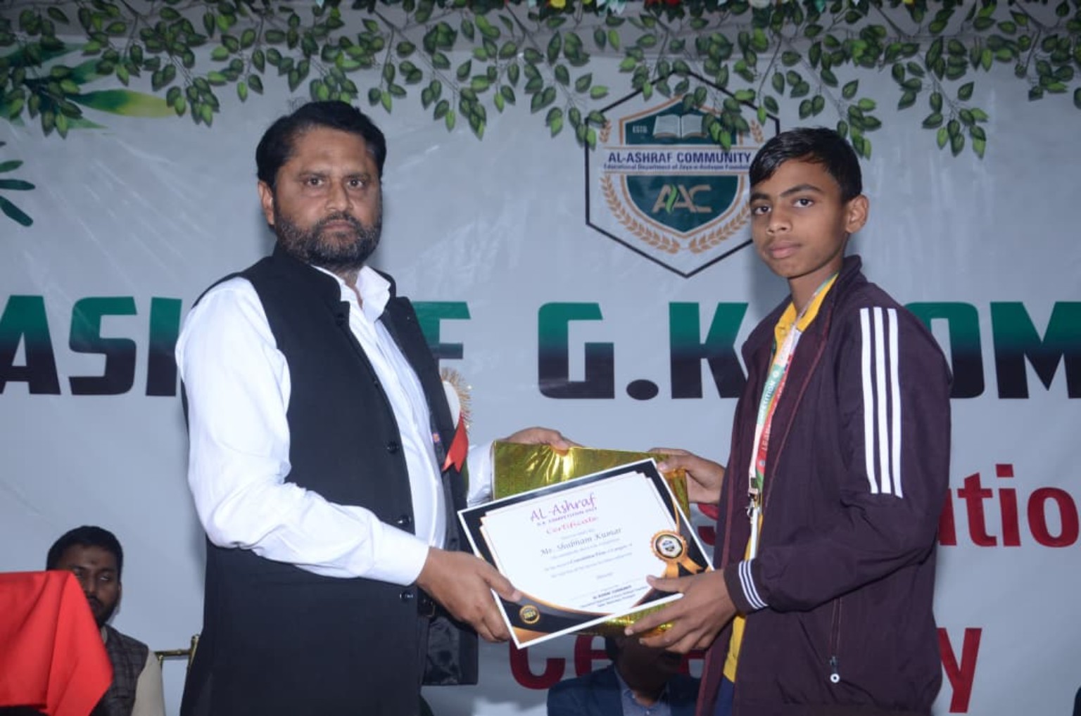Student receiving certificate and award